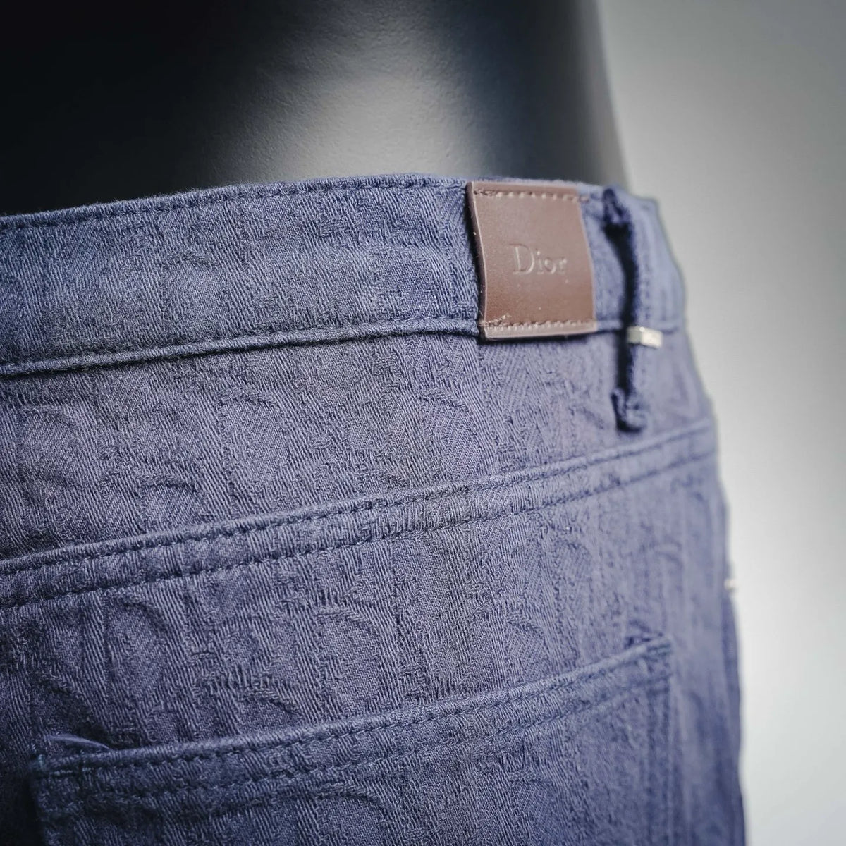 Dark blue Dior denim pants with leather logo patch and button
