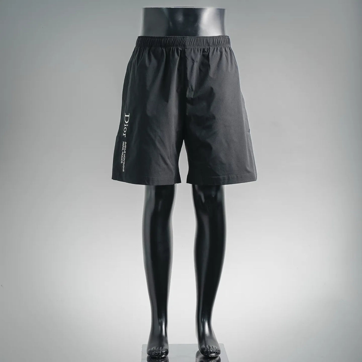 Black drawstring waist shorts with knee-length cut and side pockets