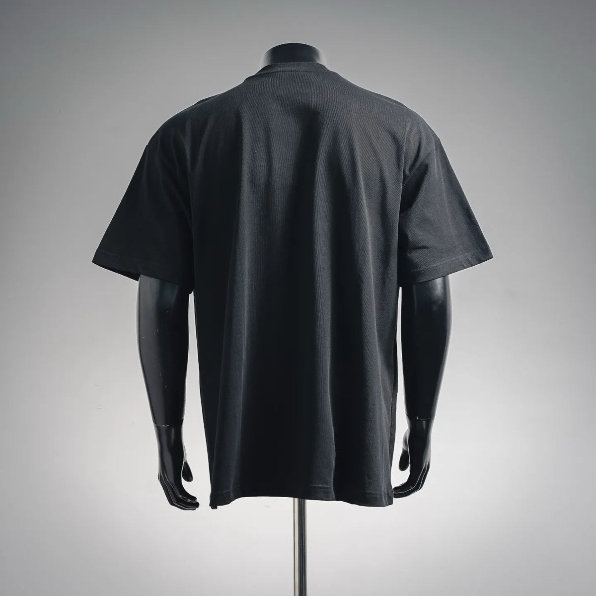 Black crewneck T-shirt, back view with short sleeves.