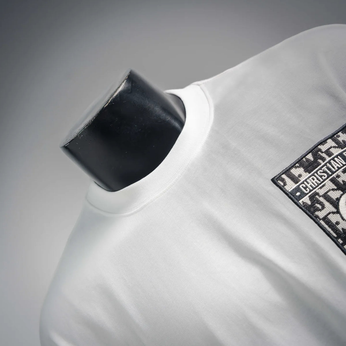 White Dior T-shirt neckline and sleeve with partial logo patch