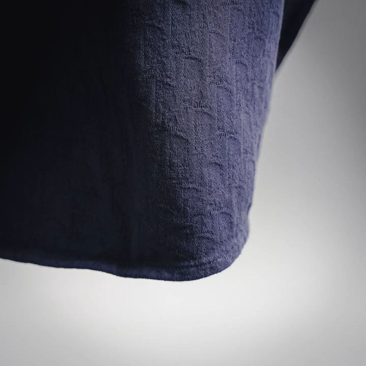 Dark navy shirt sleeve cuff and hem with textured fabric detail