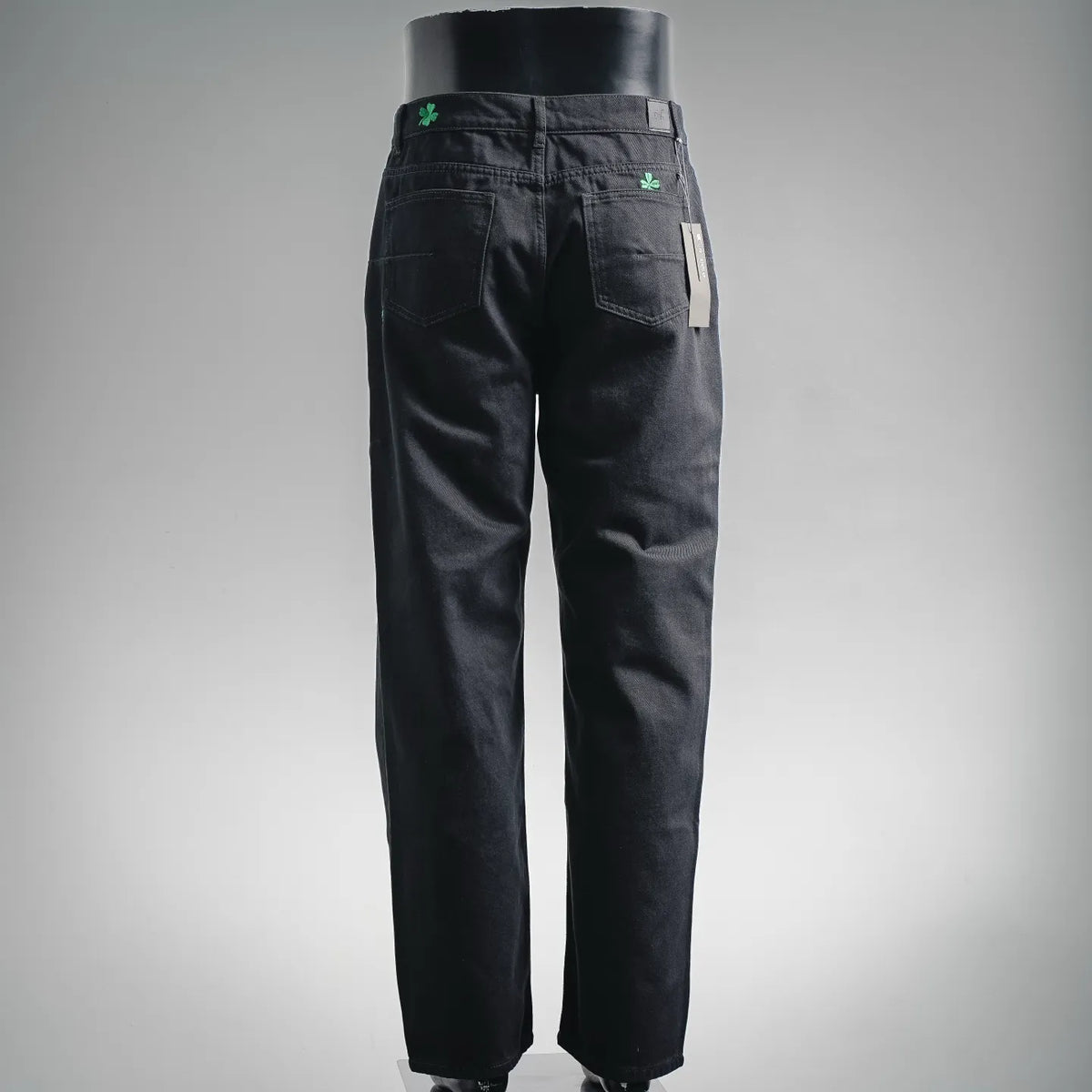 Black pants, back view with green clover accent and belt loops