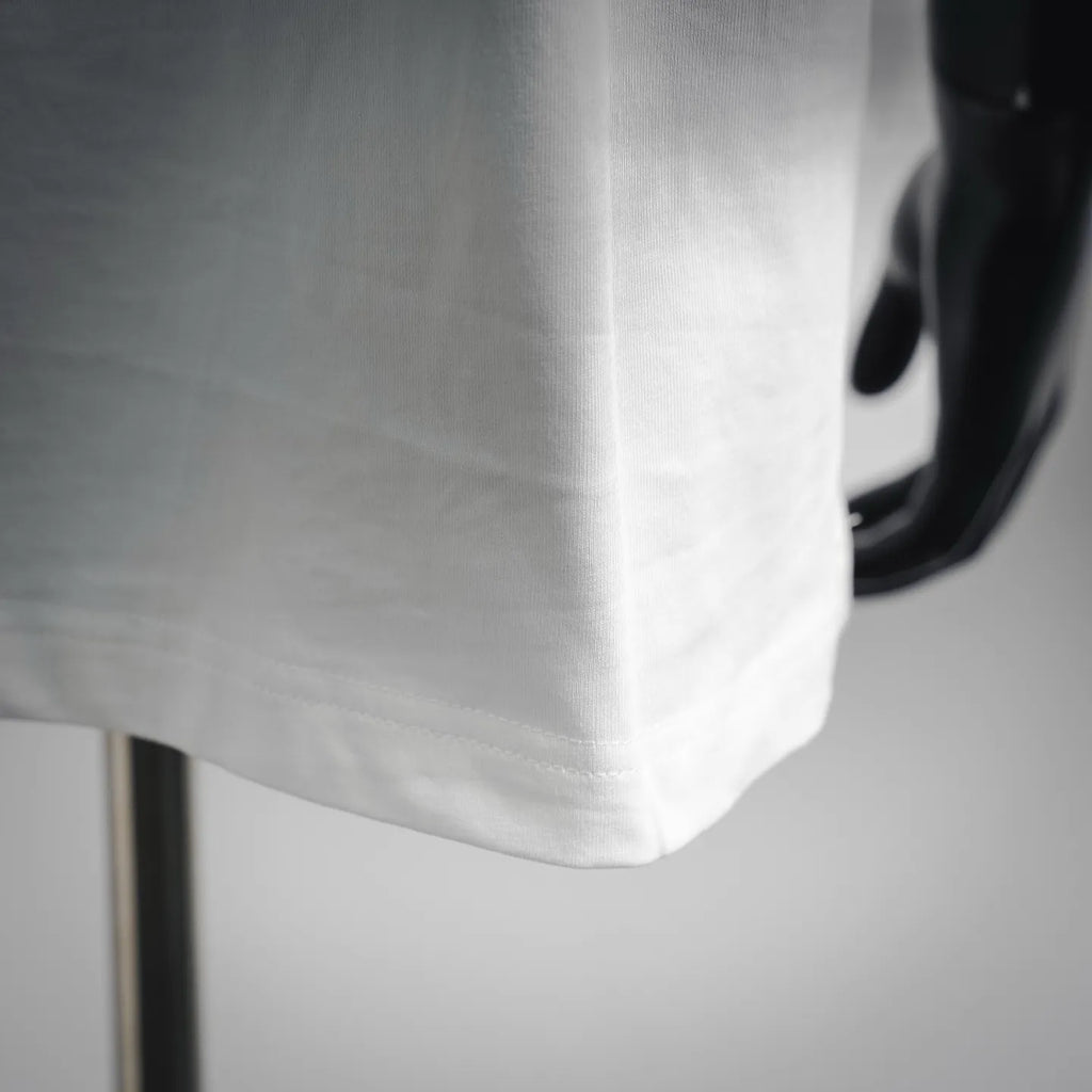 White t-shirt hem with stitched edge and side seam detail