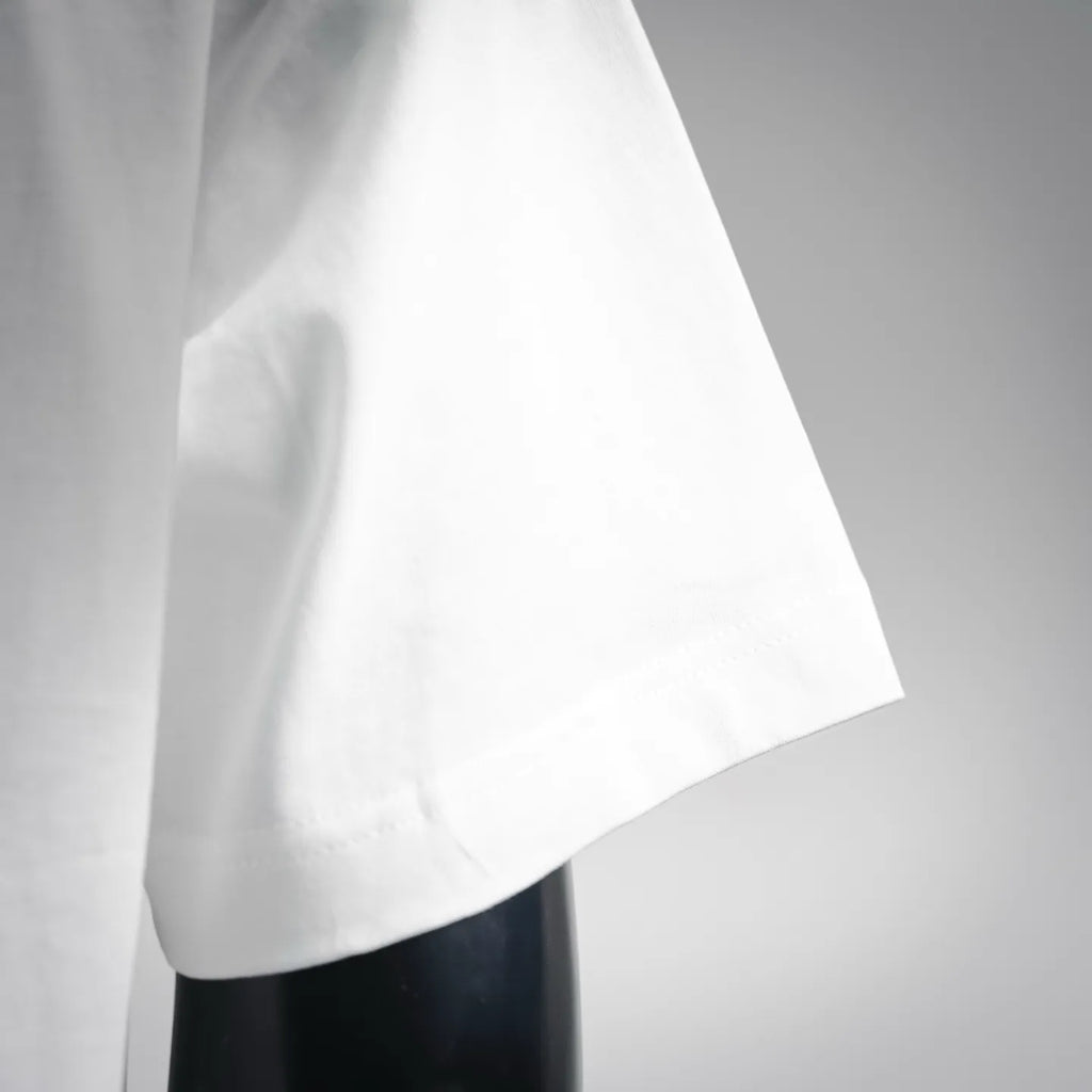 White short-sleeve t-shirt sleeve and side drape detail