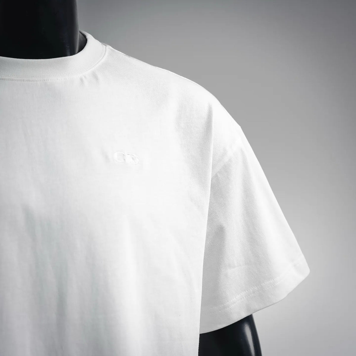 White short-sleeve t-shirt with small embossed Dior logo on chest