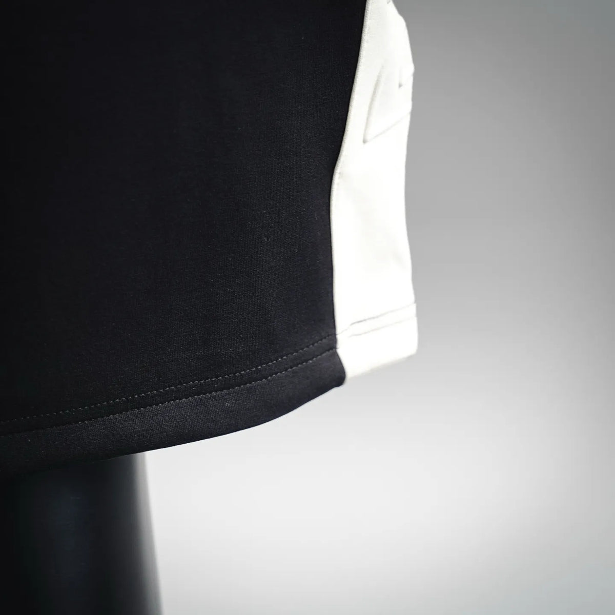 Black shorts with side panel featuring a contrast white pocket insert