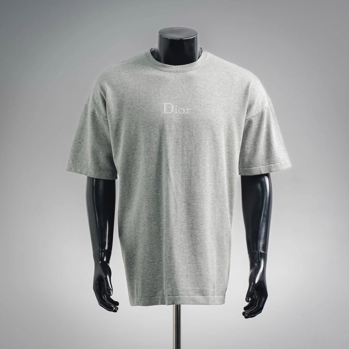 Dior short-sleeve T-shirt on mannequin, light gray crewneck with small Dior logo