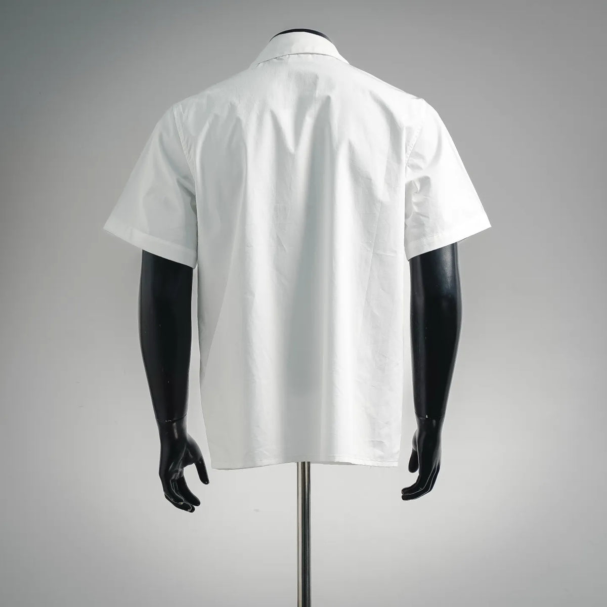 White short-sleeve button-up shirt, back view with pointed collar
