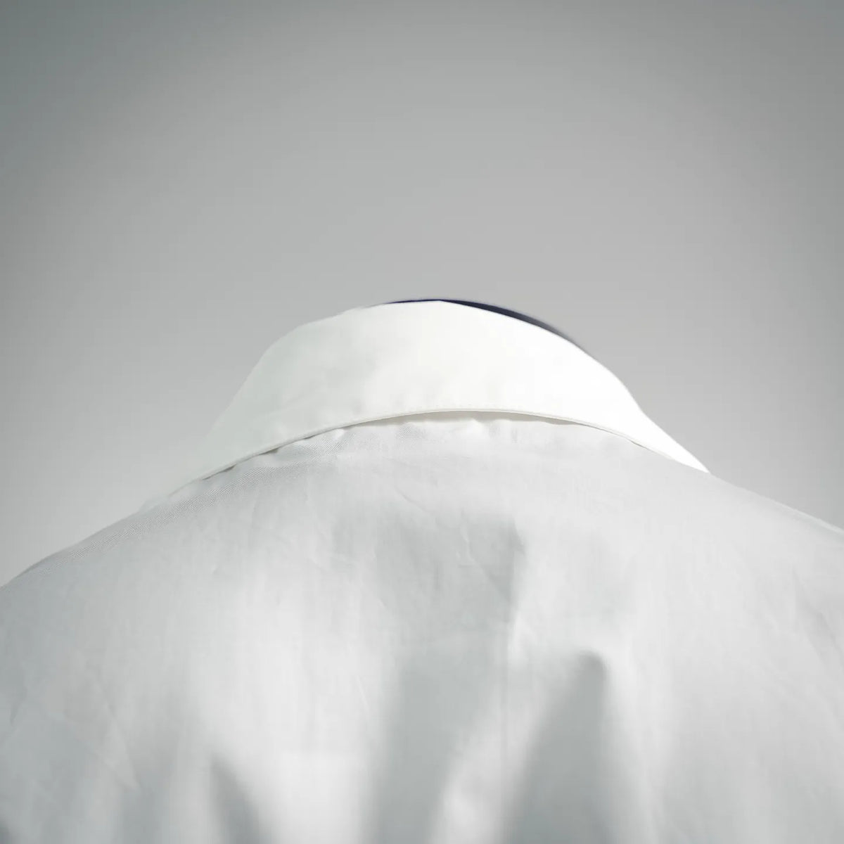 White short-sleeve button-up shirt, close view of shoulder and collar