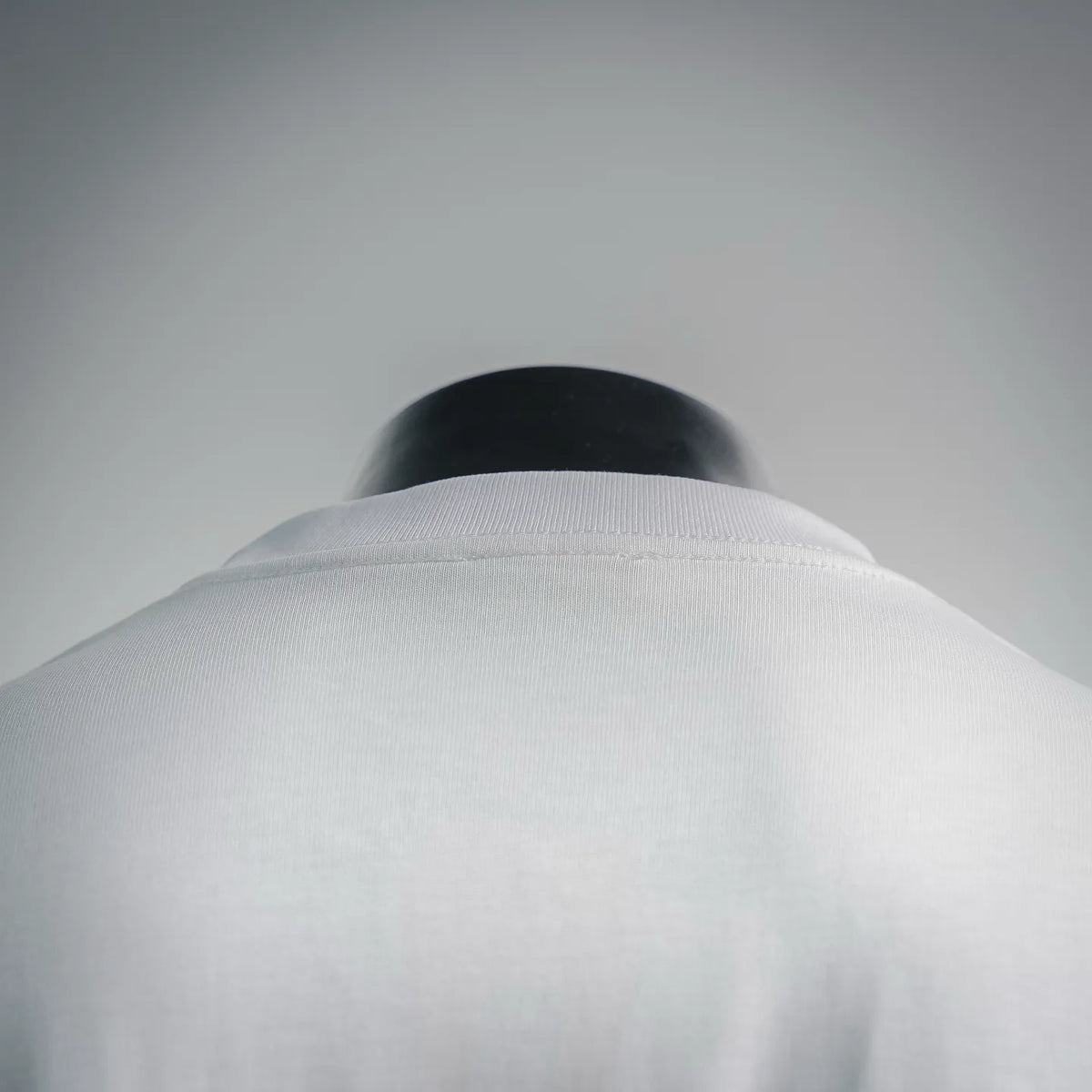 White crew-neck T-shirt collar close-up with fabric texture