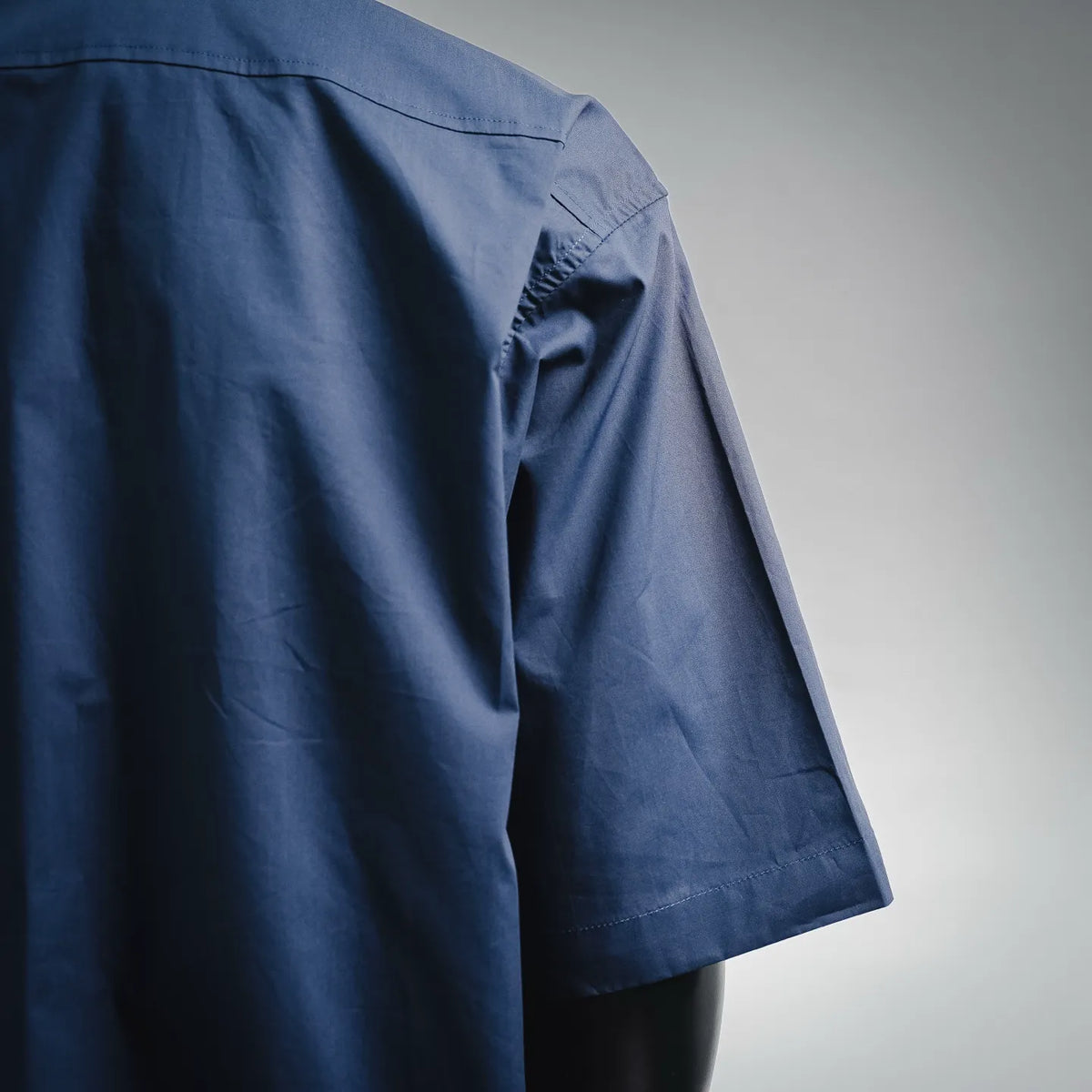 Dior short-sleeve shirt in dark blue with stitched sleeve seam and folded cuff detail
