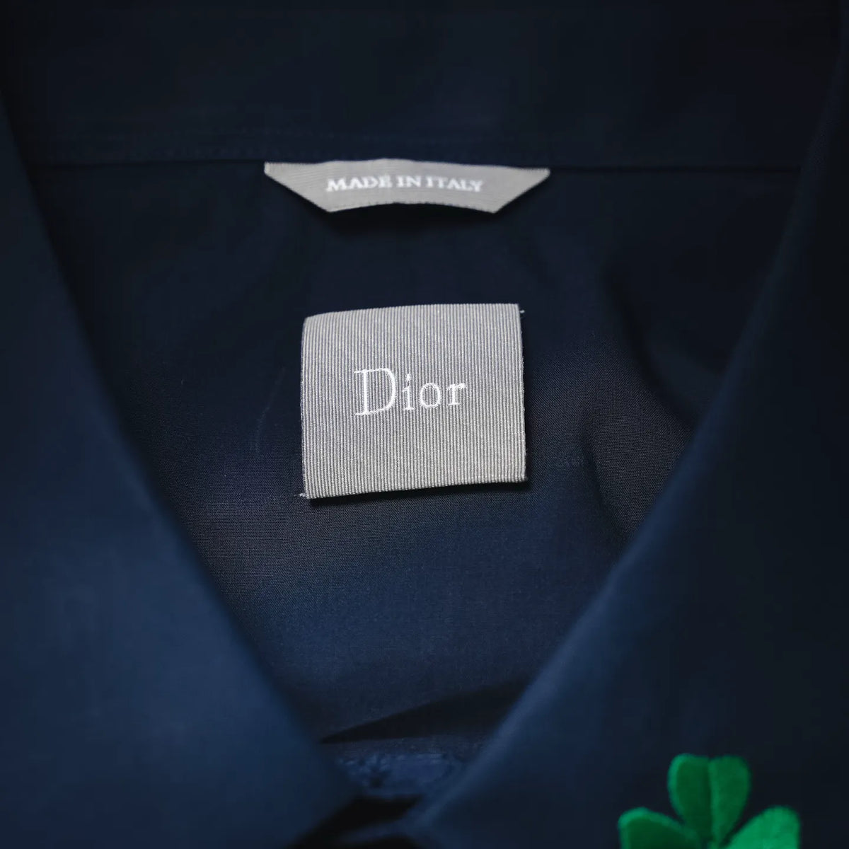 Dior fabric label on dark blue shirt neckline; interior tag reads Dior and Made in Italy