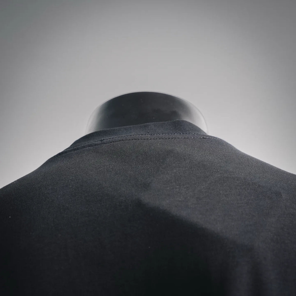 Black crew-neck T-shirt collar close-up