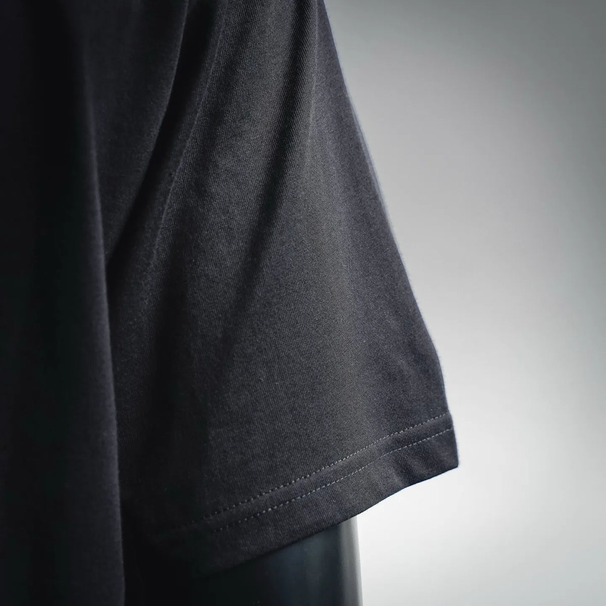 Black Dior T-shirt hem and short sleeve seam detail