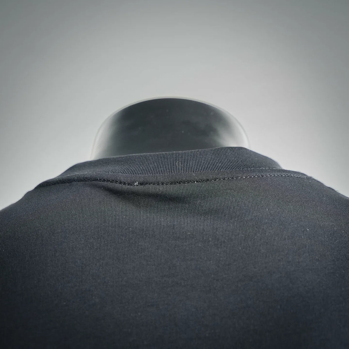 Black T-shirt neckline and shoulder seam close-up