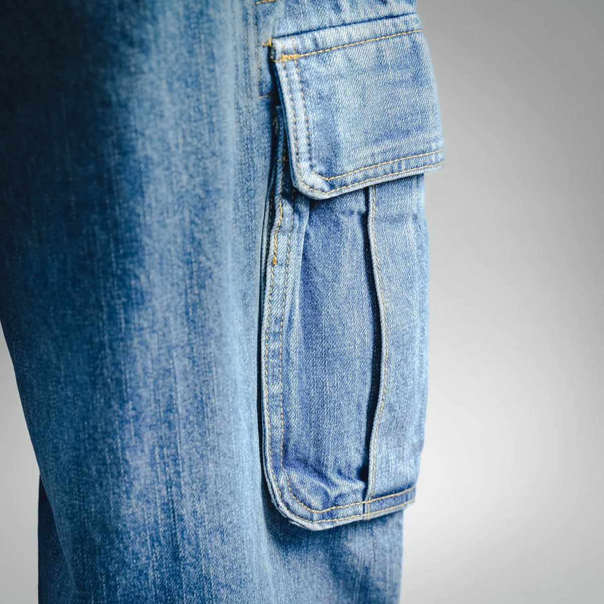 Light blue denim Dior pants with front cargo pocket and stitched trim