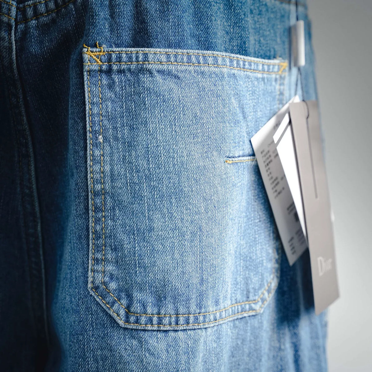 Light blue denim Dior cargo pants with back pocket and hanging tag