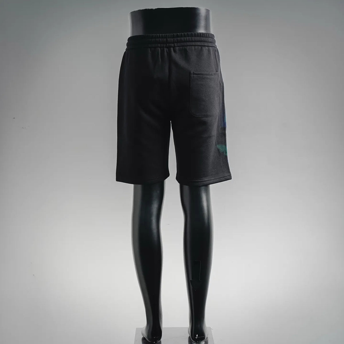 Black Dior shorts with elastic waistband and subtle blue-green logo detail