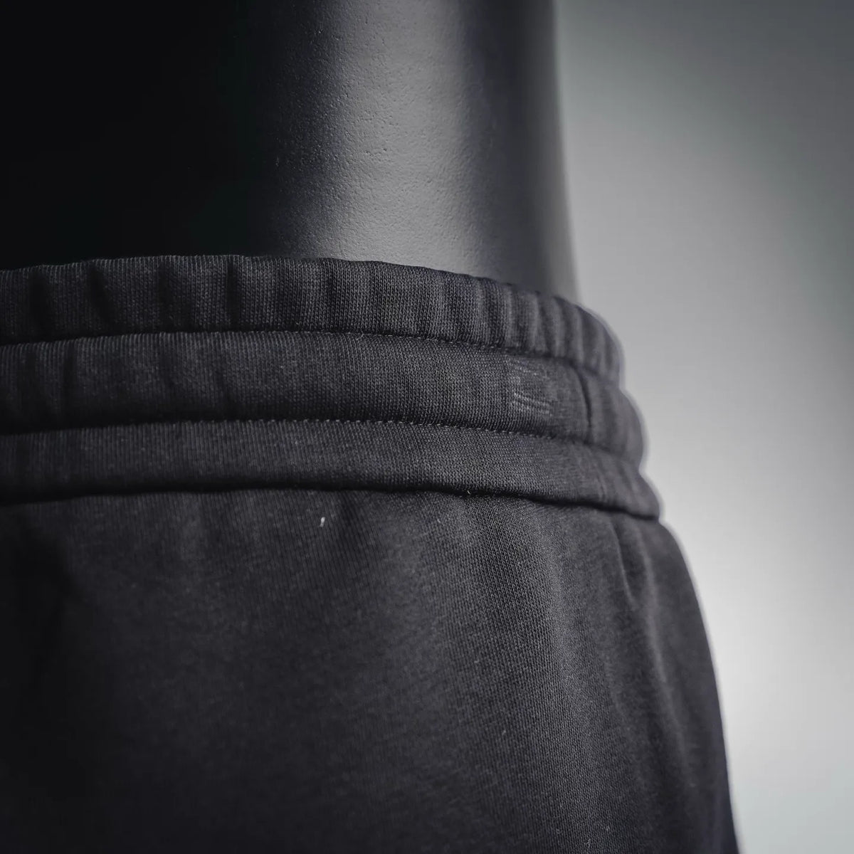 Black elastic waistband and drawstring seam on Dior shorts