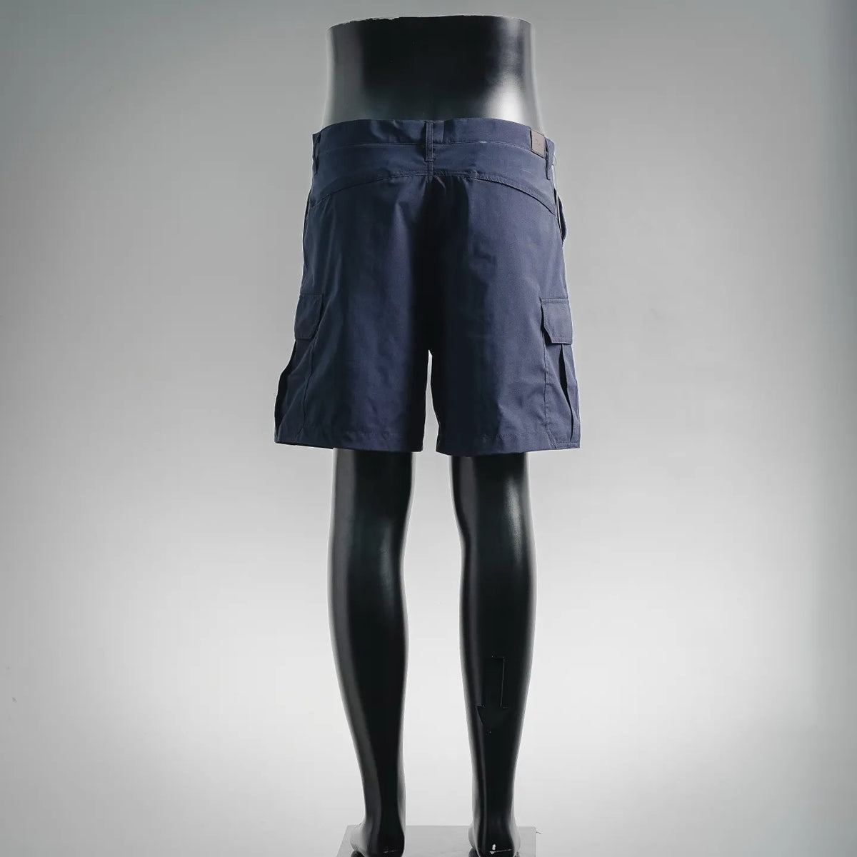 Navy cargo shorts on mannequin with belt loops and flap cargo pockets
