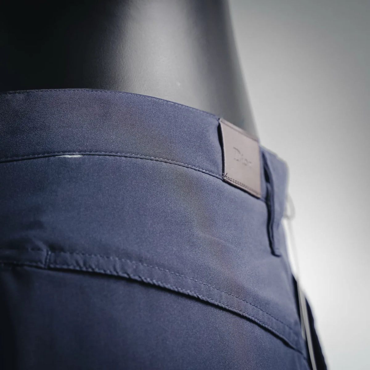 Close-up of navy cargo shorts waistband and stitched pocket edge