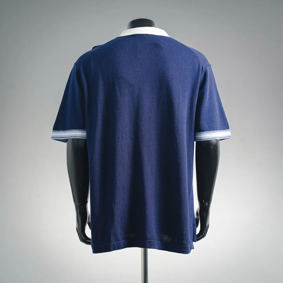 Navy Dior polo shirt, back view with striped sleeve cuffs