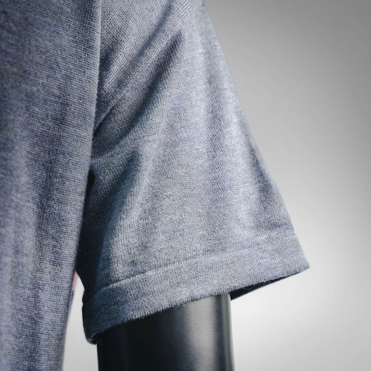 Heather blue short-sleeve T-shirt sleeve cuff and side seam close-up
