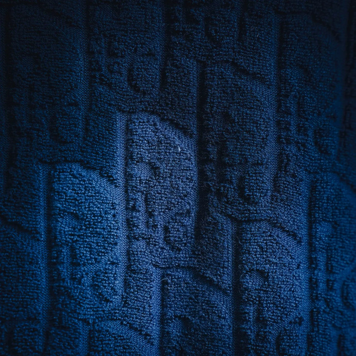 Close-up of Dior blue textured monogram knit fabric on T-shirt