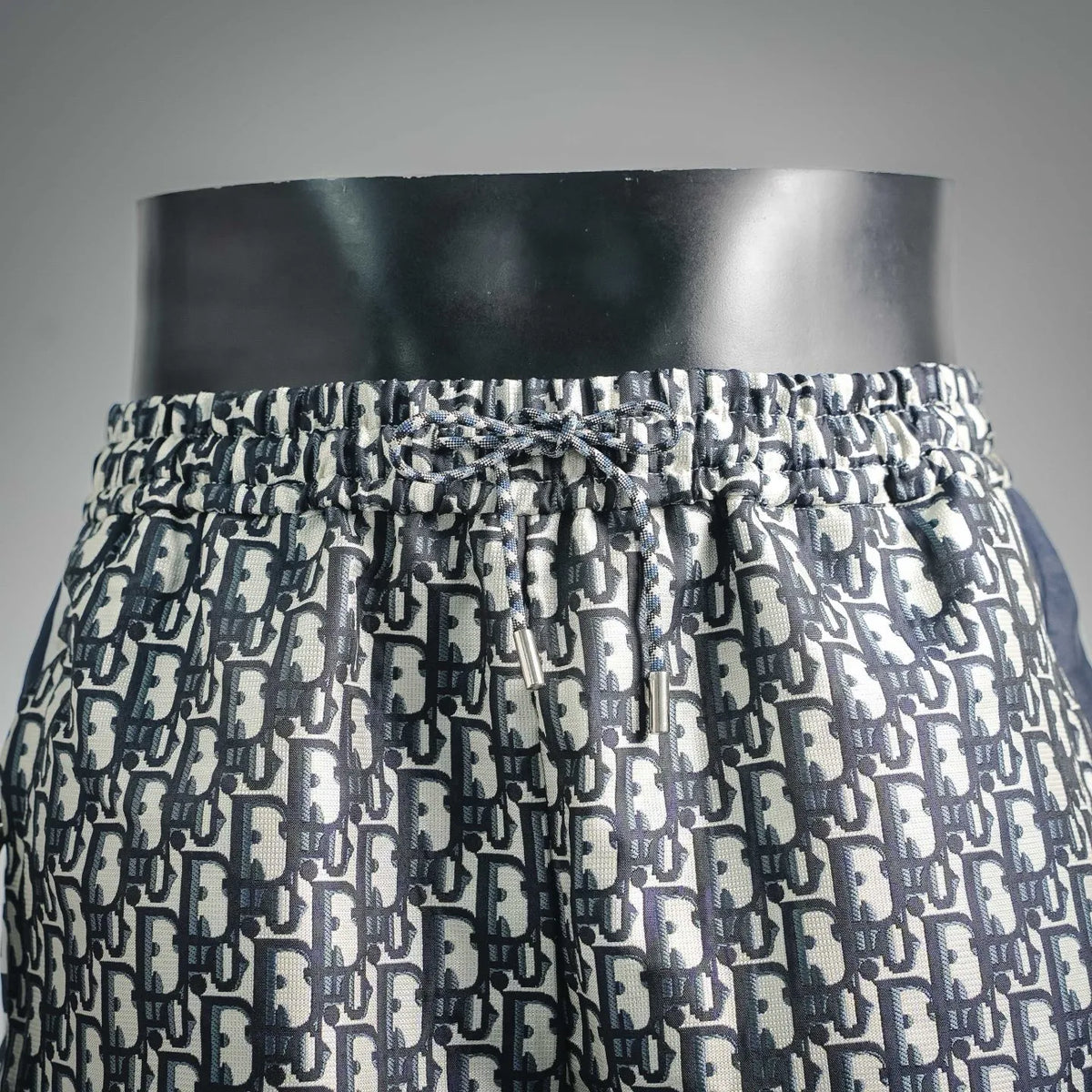 Dior monogram shorts with elastic waistband, navy and cream repeating pattern