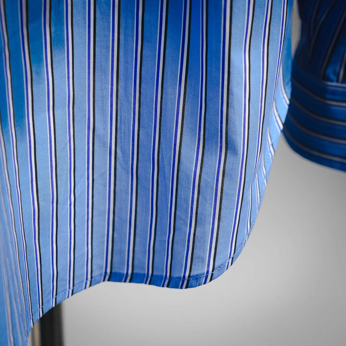 Close-up of Dior blue and white vertically striped shirt fabric