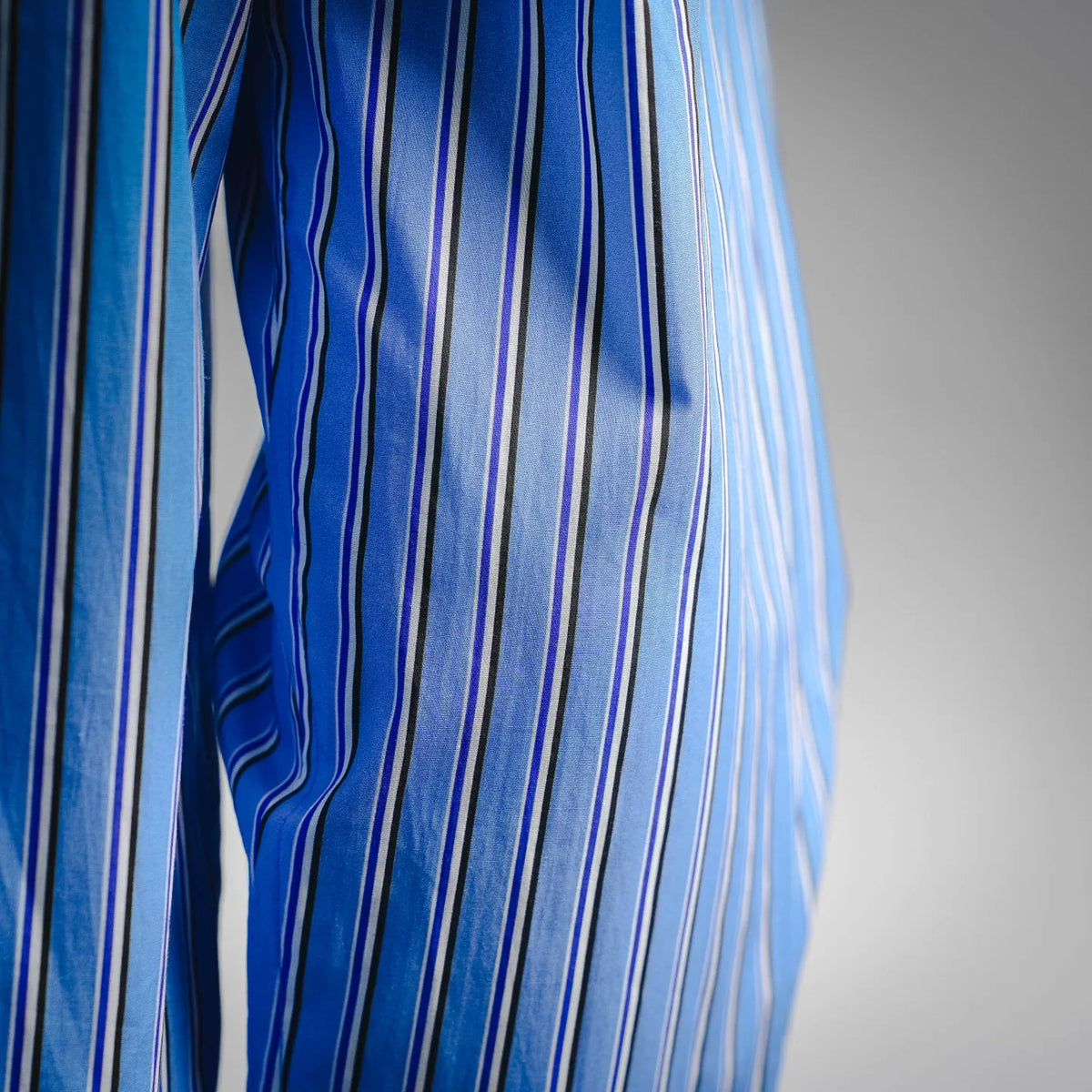 Side view of Dior long-sleeve shirt with blue and white vertical stripes