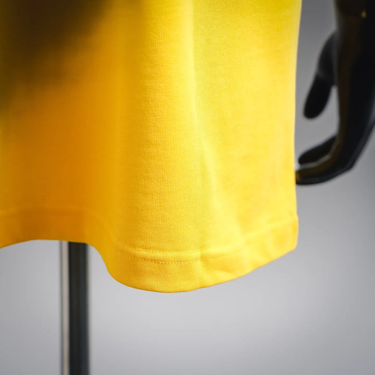 Yellow T-shirt hem and stitching detail