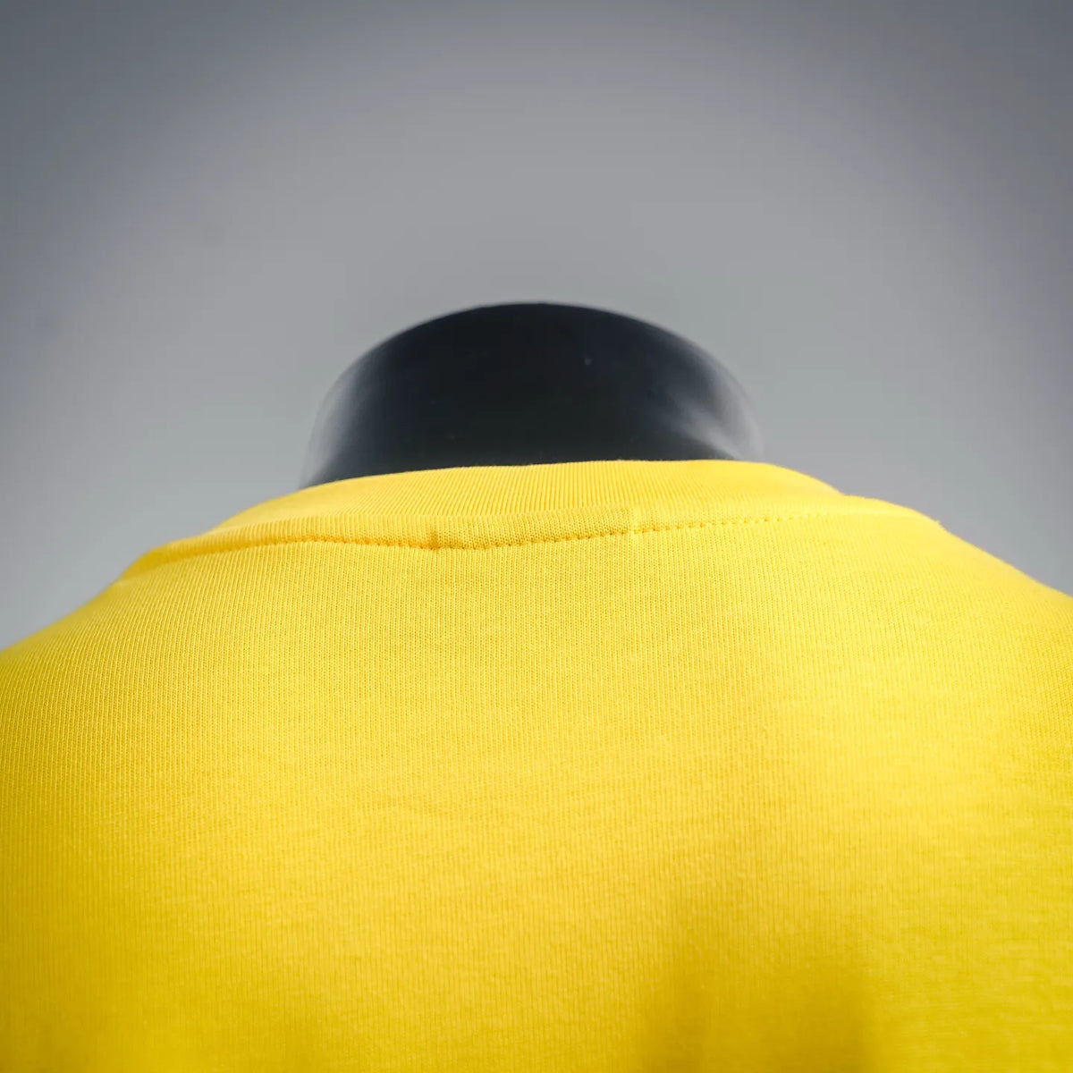 Yellow T-shirt back neckline and shoulder seam detail