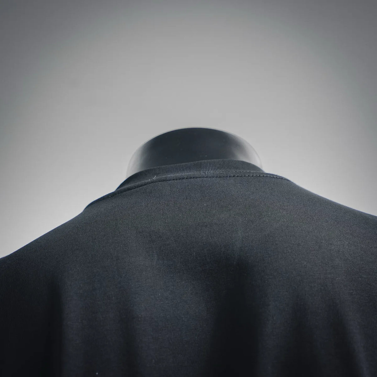Black T-shirt neckline and shoulder from the back