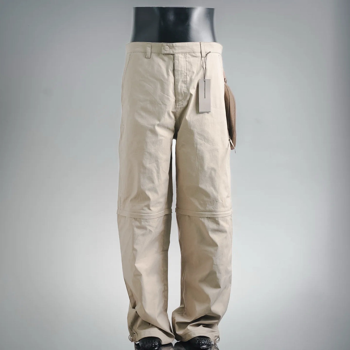 Dior tan pants with belt loops, zip fly, slanted front pockets, ankle cuff ties