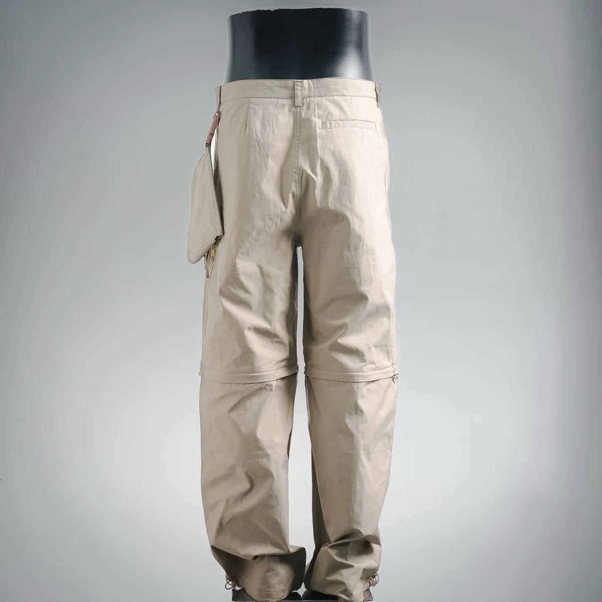 Tan pants with belt loops and button closure; back view shows ankle cuff ties
