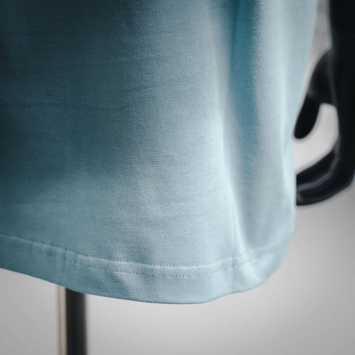Light blue T-shirt hem with stitched edge and short-sleeve cuff
