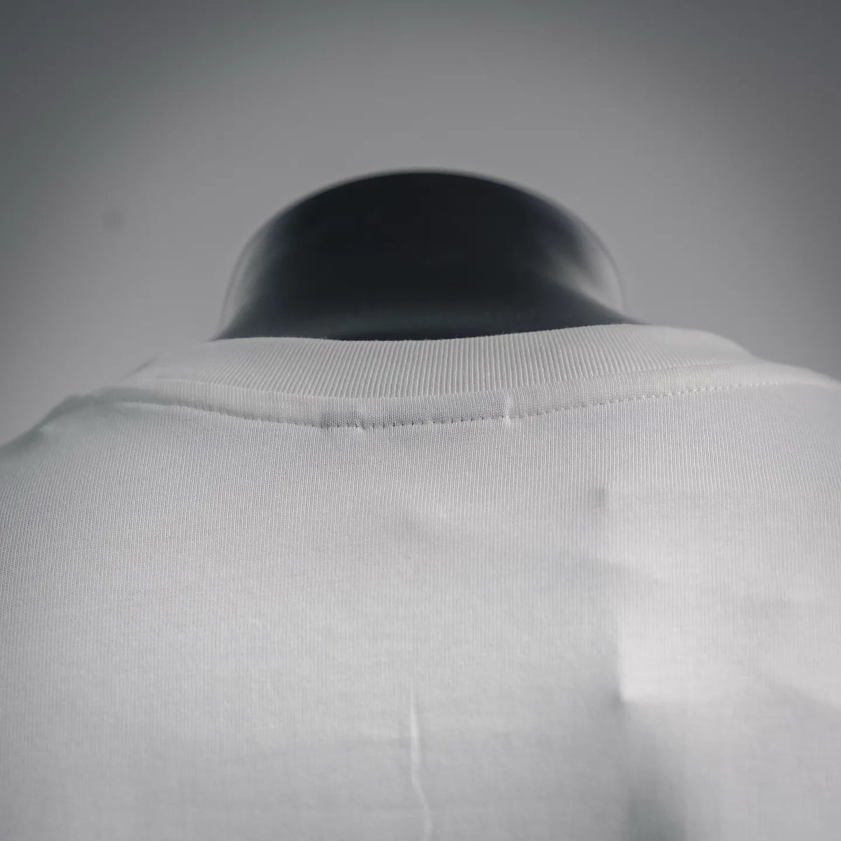 White T-shirt collar and upper back seam detail