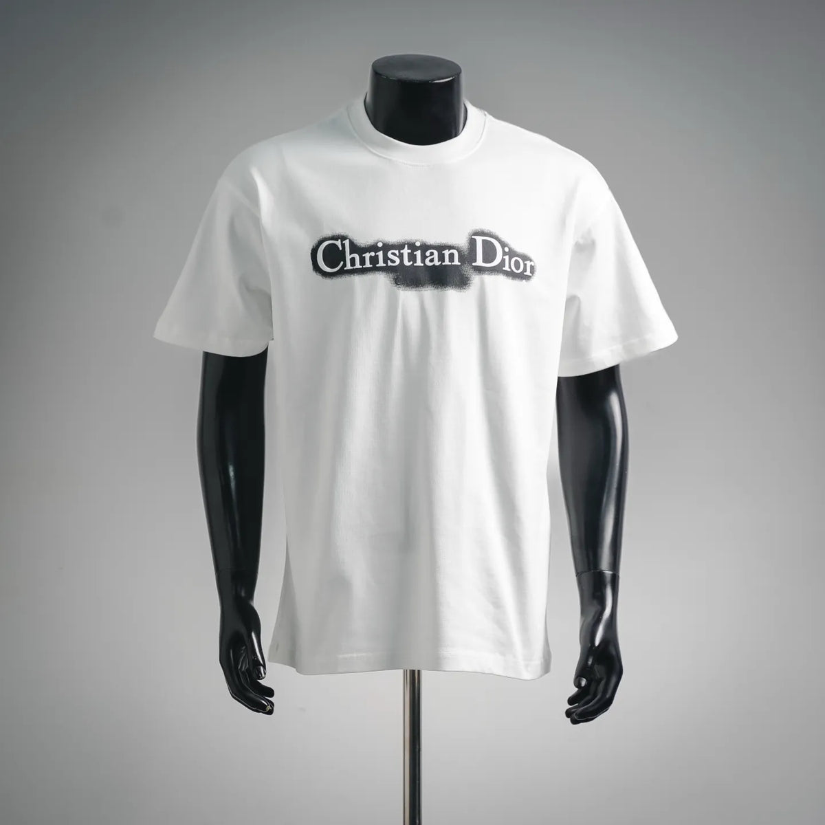 White crew-neck short-sleeve T-shirt on mannequin with Christian Dior front logo.