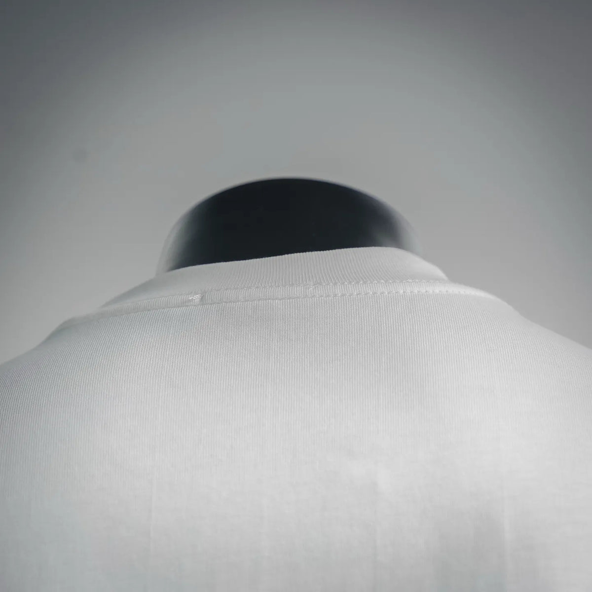 White T-shirt back neckline and collar seam detail on mannequin.