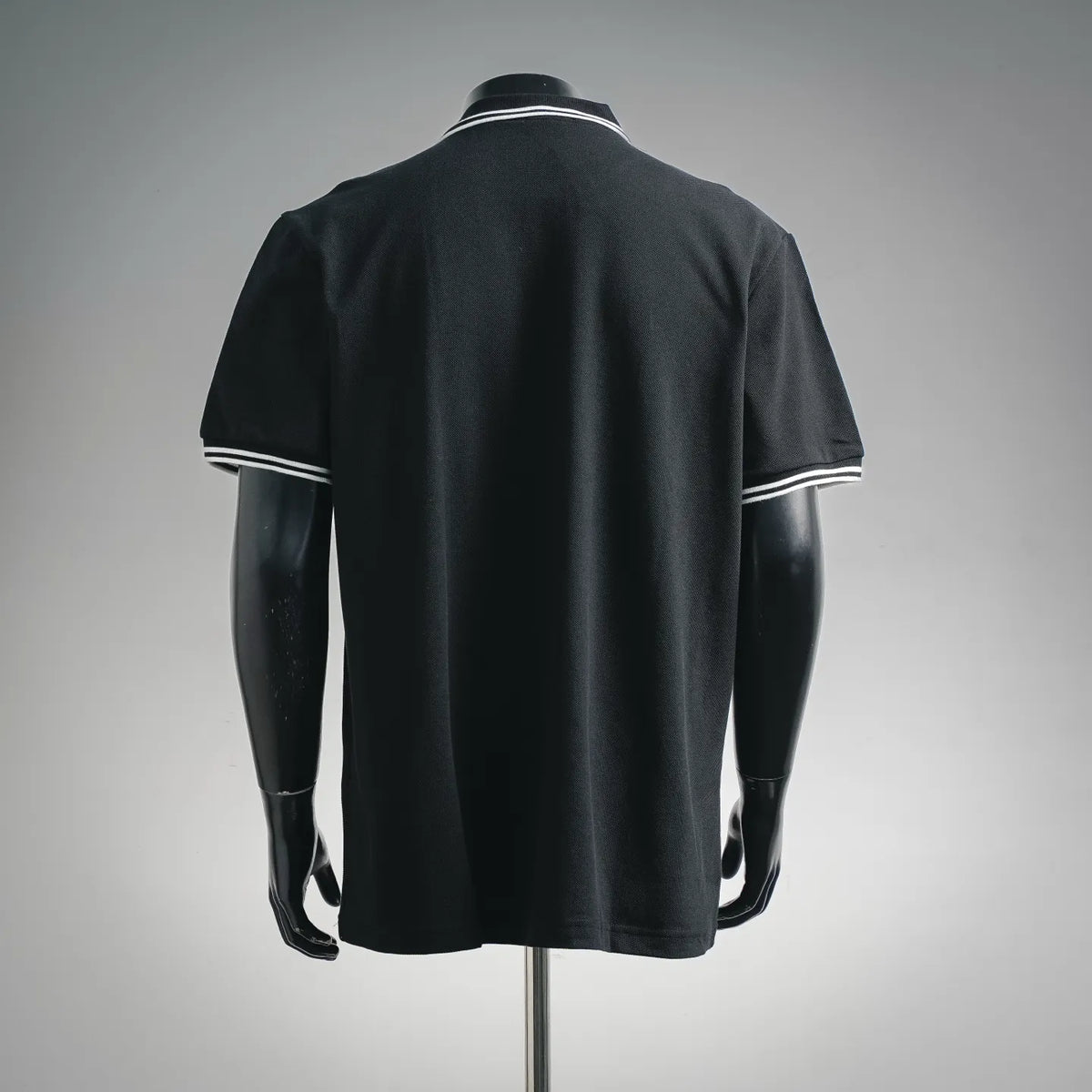 Black short-sleeve polo shirt with striped collar and sleeve cuffs