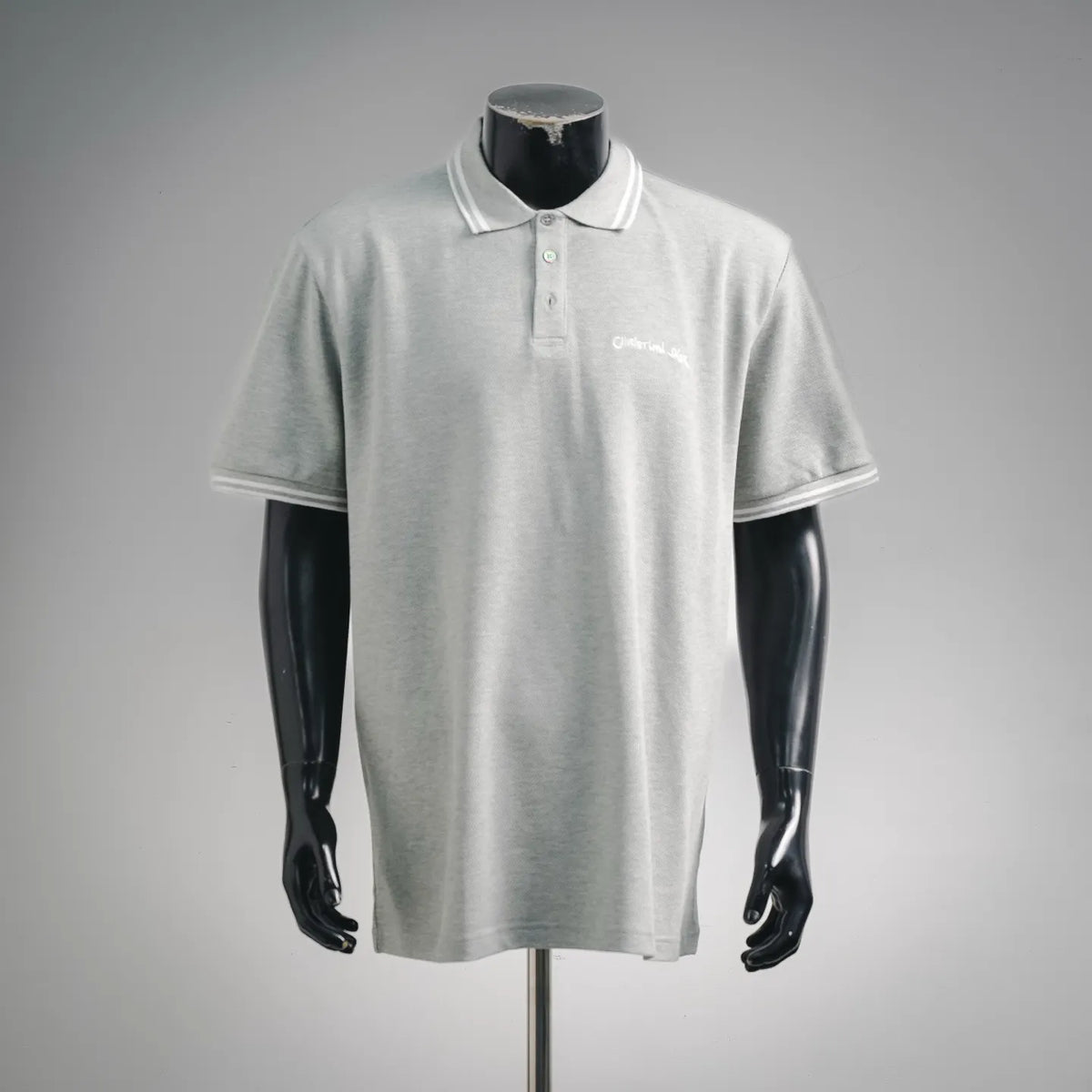 Light gray polo shirt with button placket and white trim on collar and sleeves
