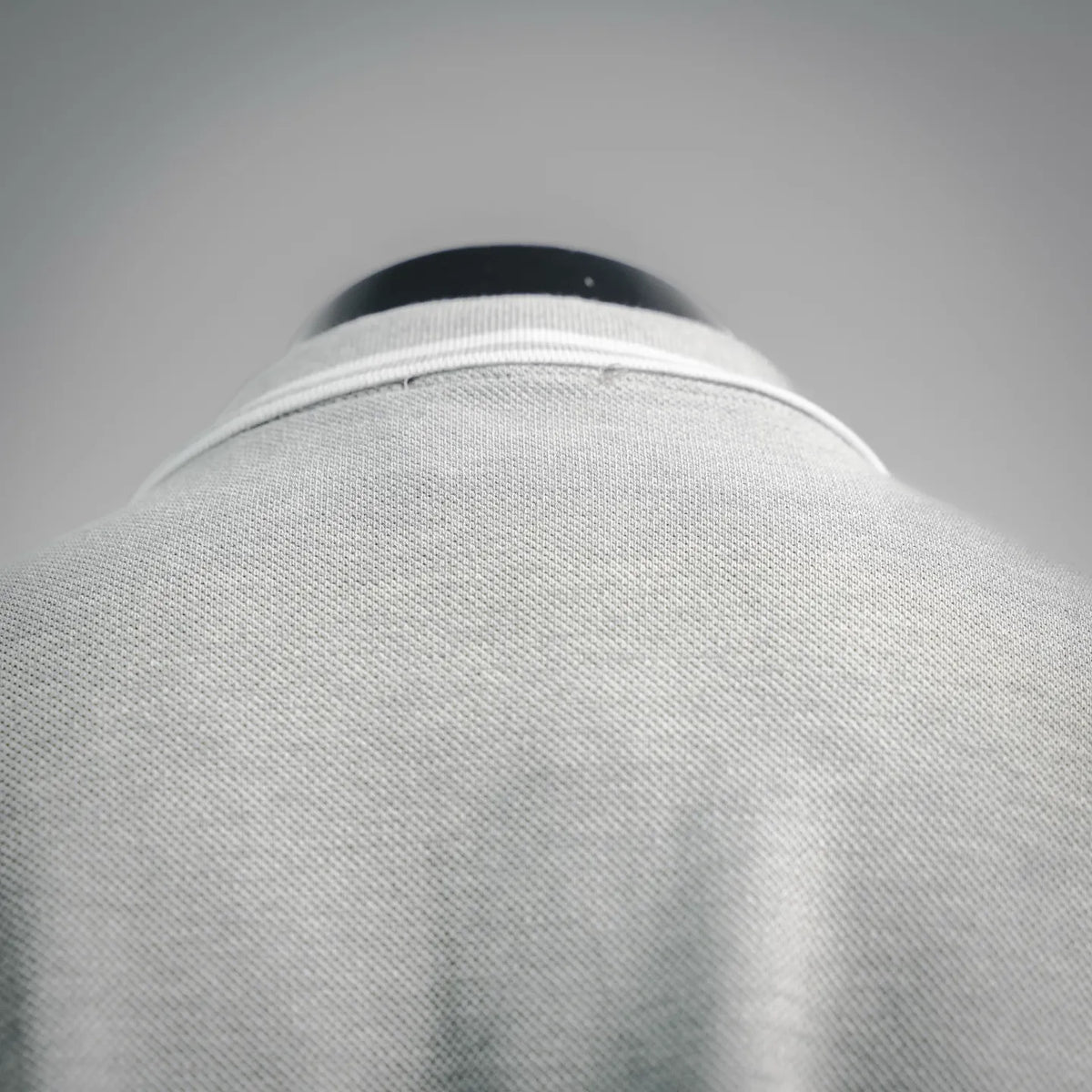 Light gray polo shirt back with ribbed collar trim