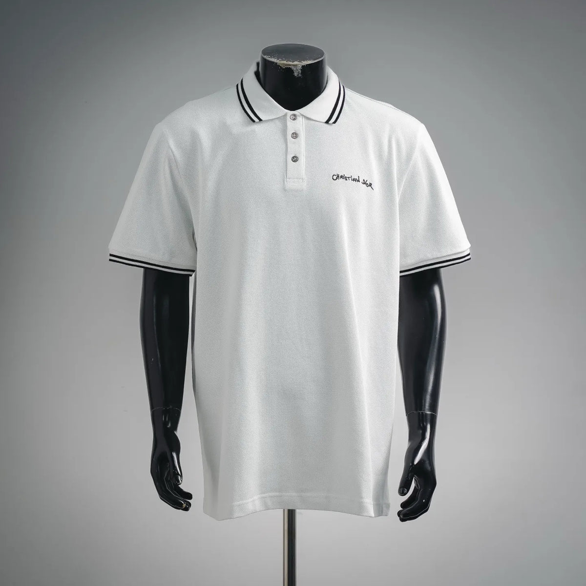 White polo shirt with navy striped collar and button placket, small chest logo