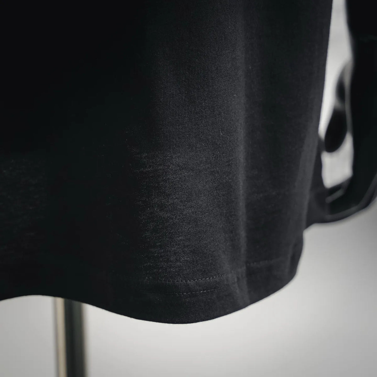 Black Dior T-shirt lower front hem close-up