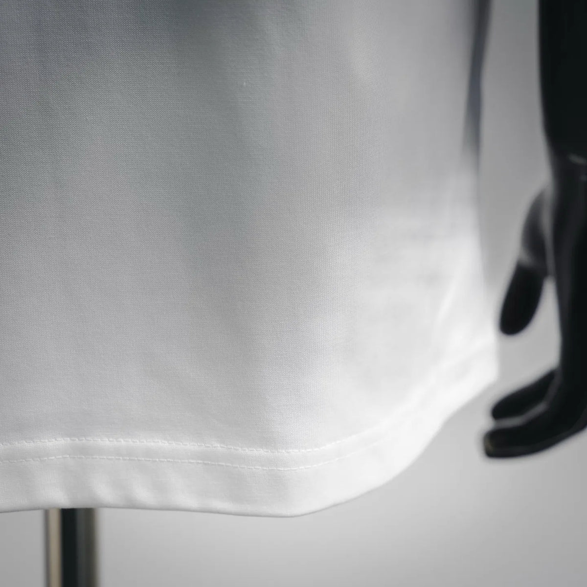 Close-up of white short-sleeve T-shirt hem and stitching