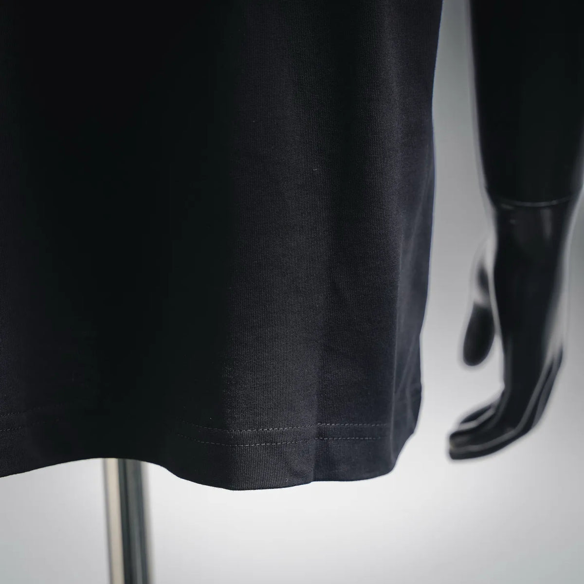 Black T-shirt hem and side seam detail