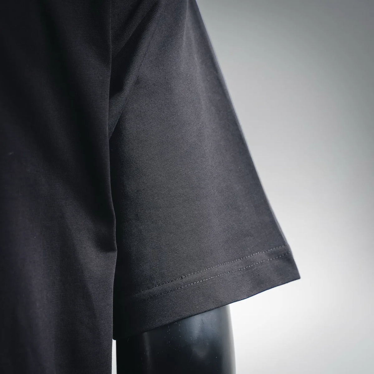 Black T-shirt sleeve hem with stitched edge