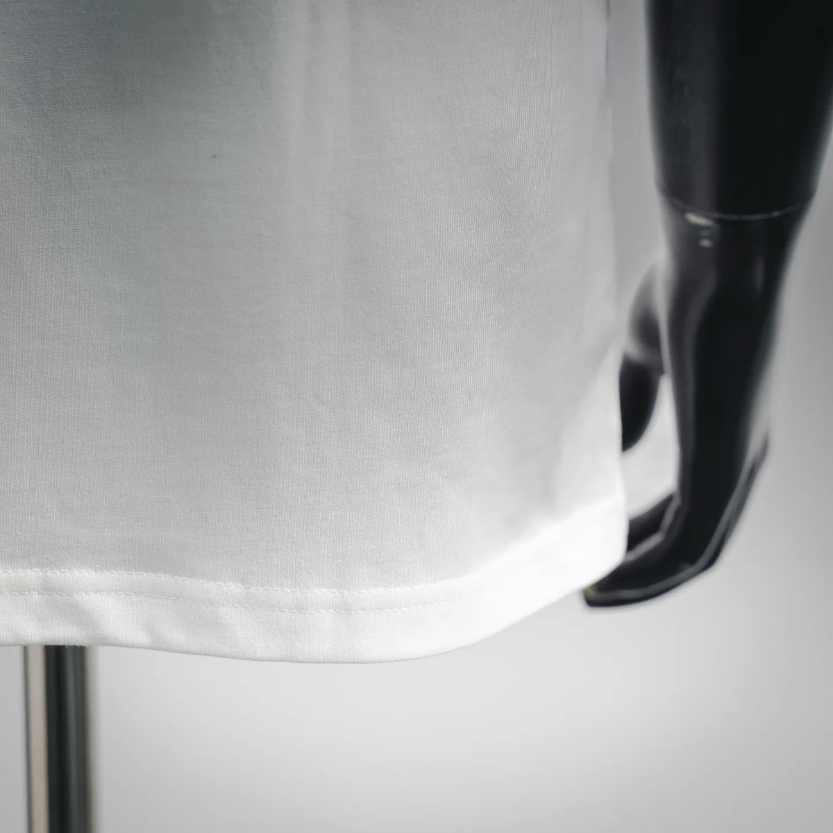 White T-shirt hem and side seam stitching, close-up
