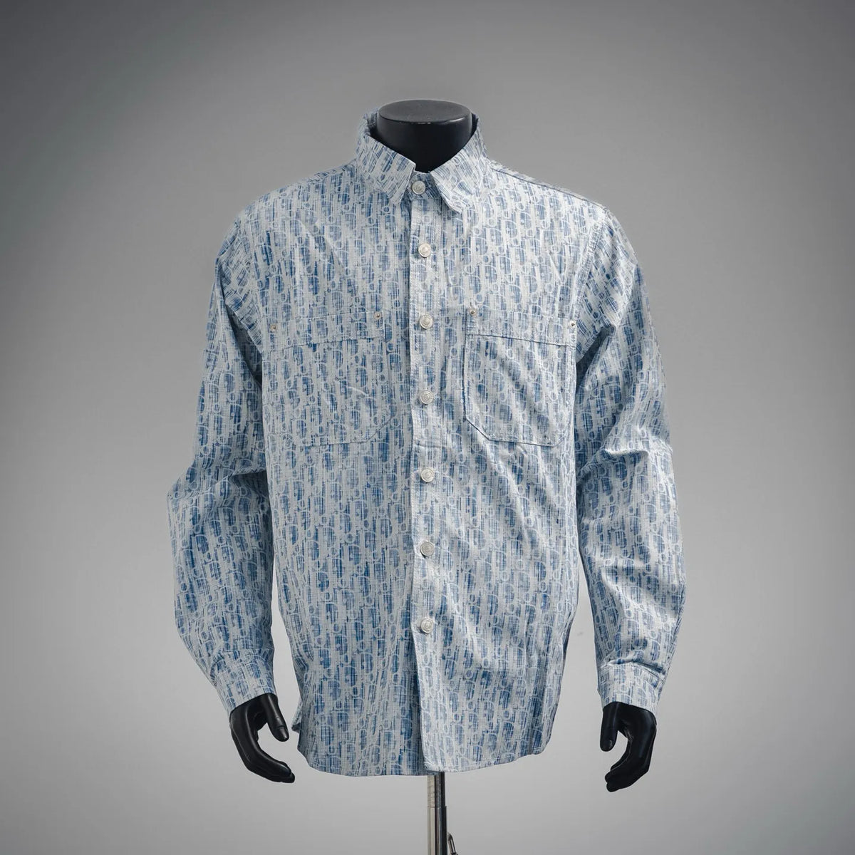 Light blue patterned long-sleeve button-up shirt with chest pocket and front buttons.